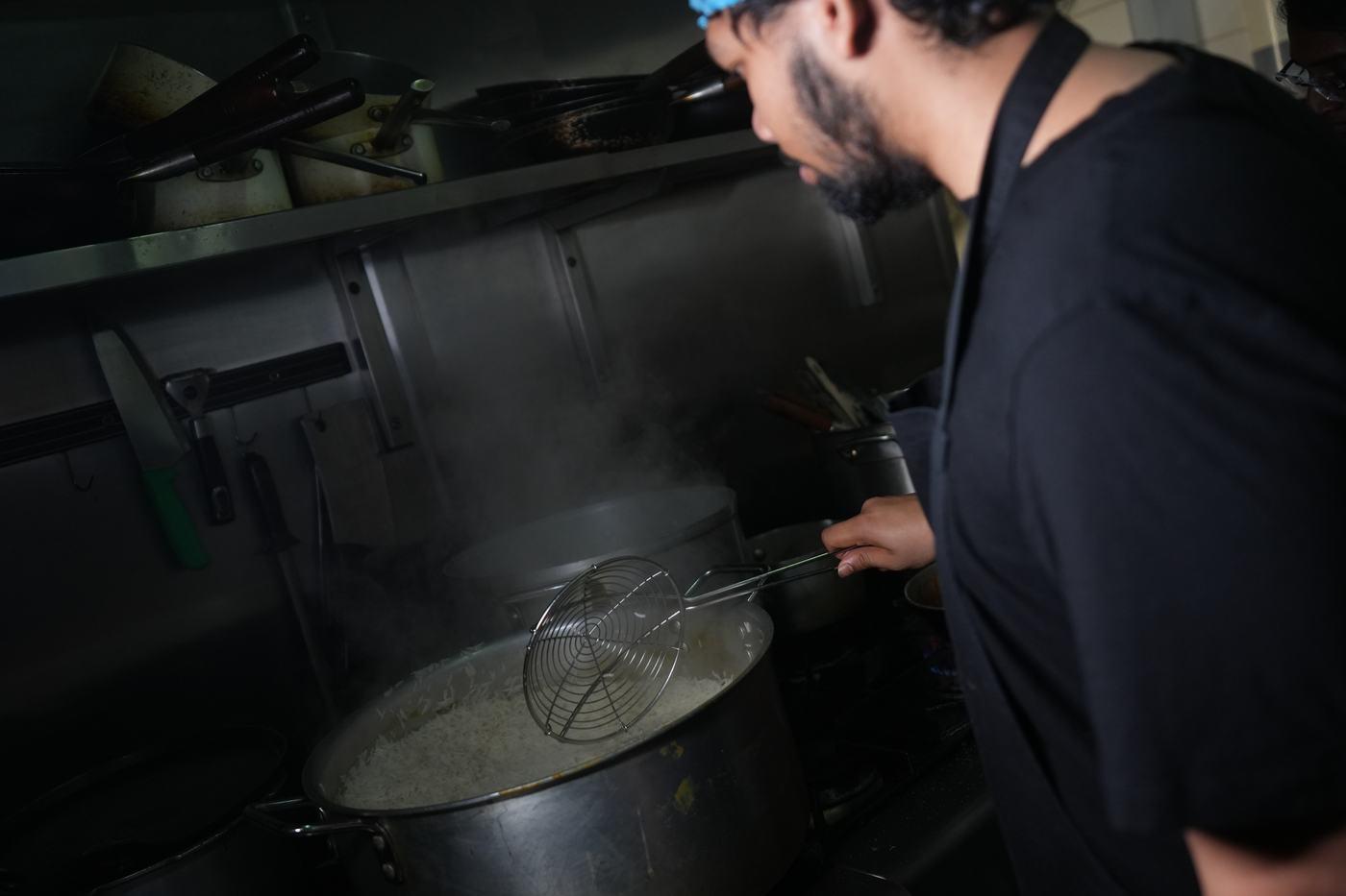 A slow-cooked curry being stirred in a large pot