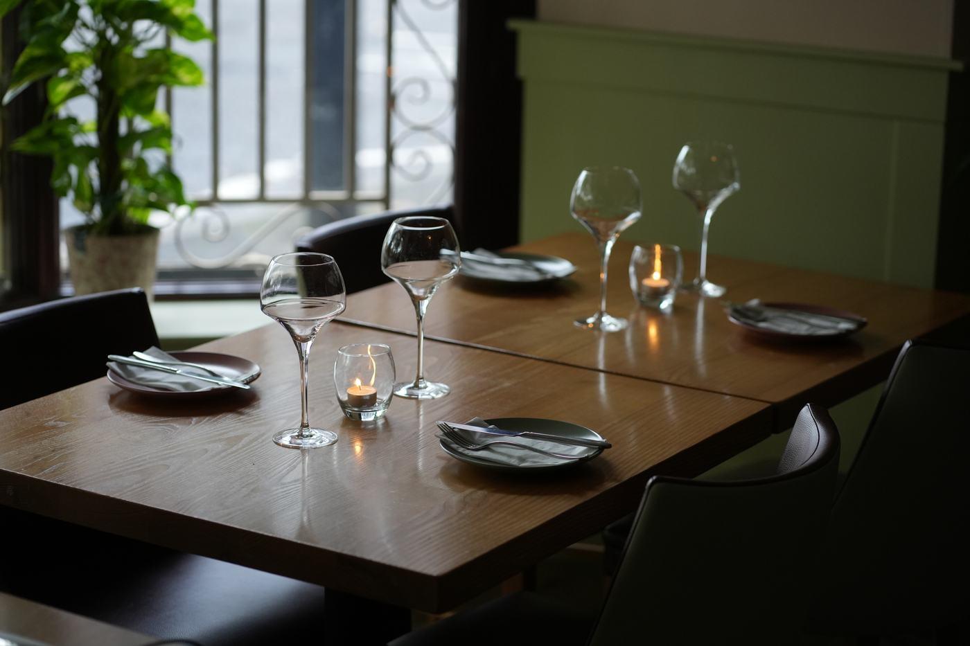 A table set for the evening with serving dishes and warm candlelight